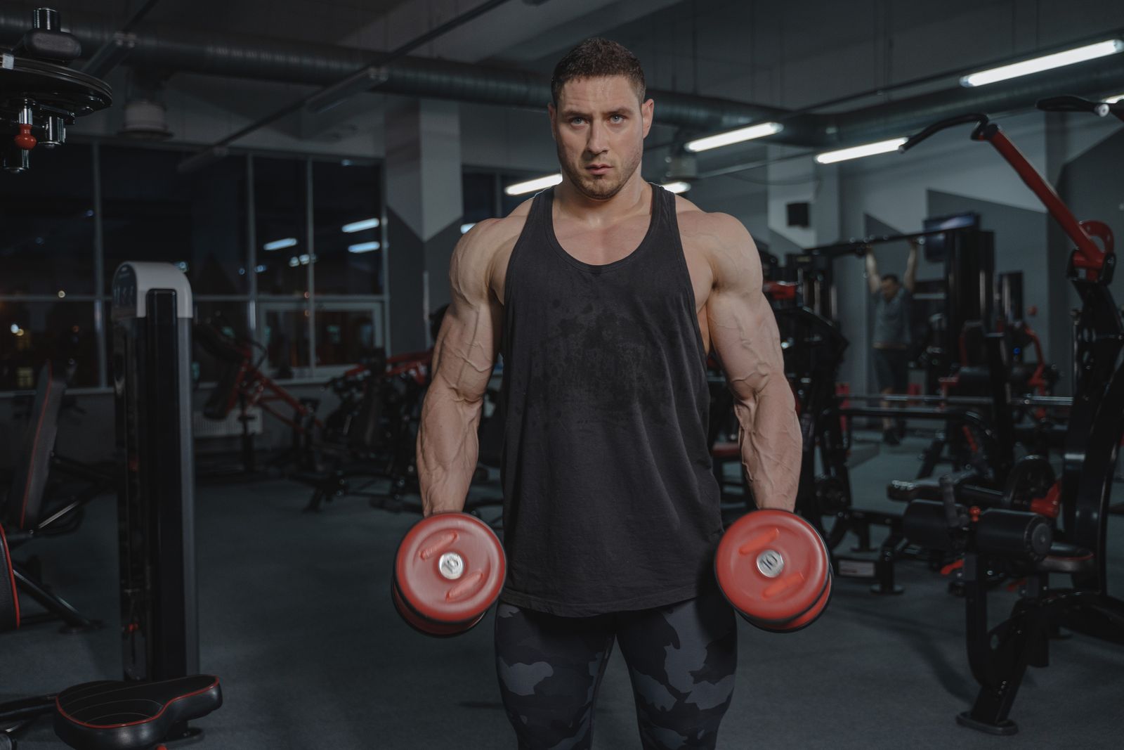 Athlete training with dumbbells in a dedicated gym