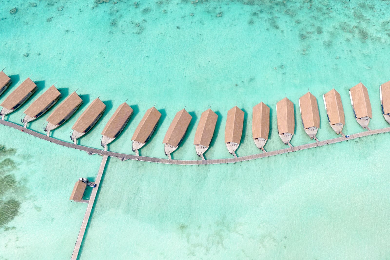 Turquoise ocean and overwater villas on a tropical island