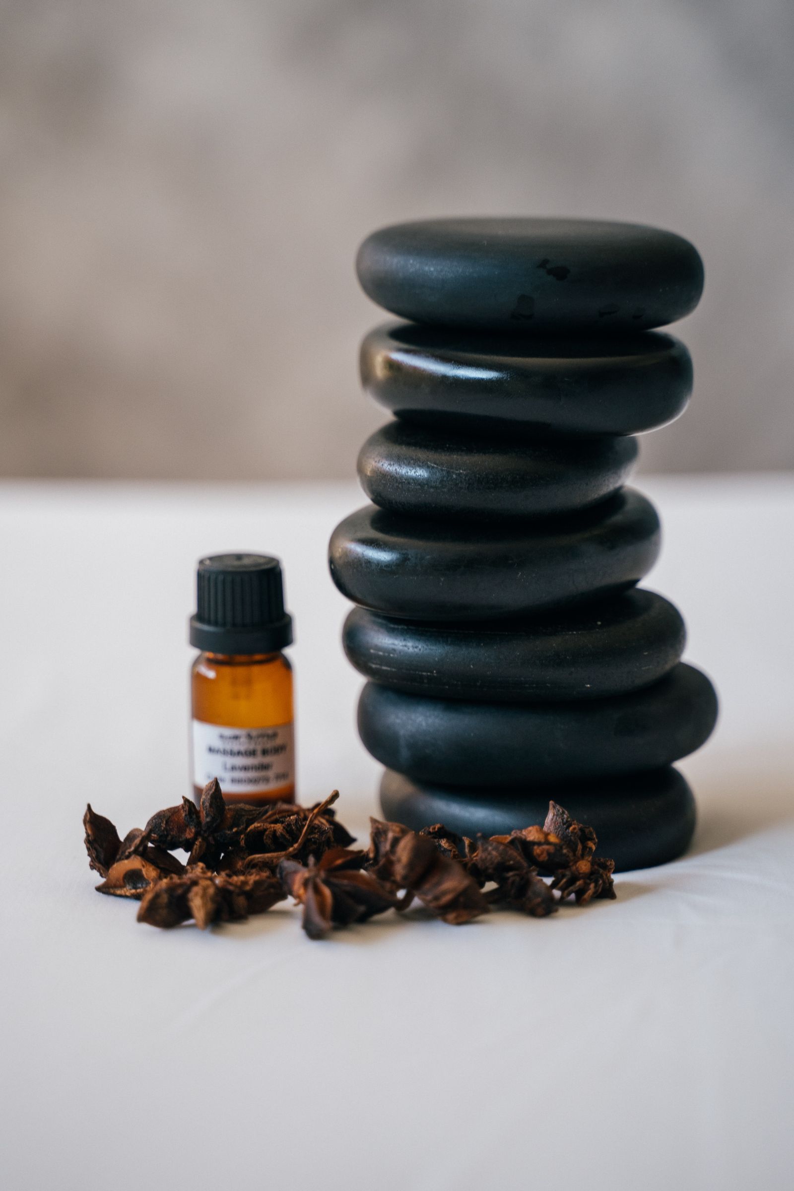 Spa stones and botanical oils arranged in soft light
