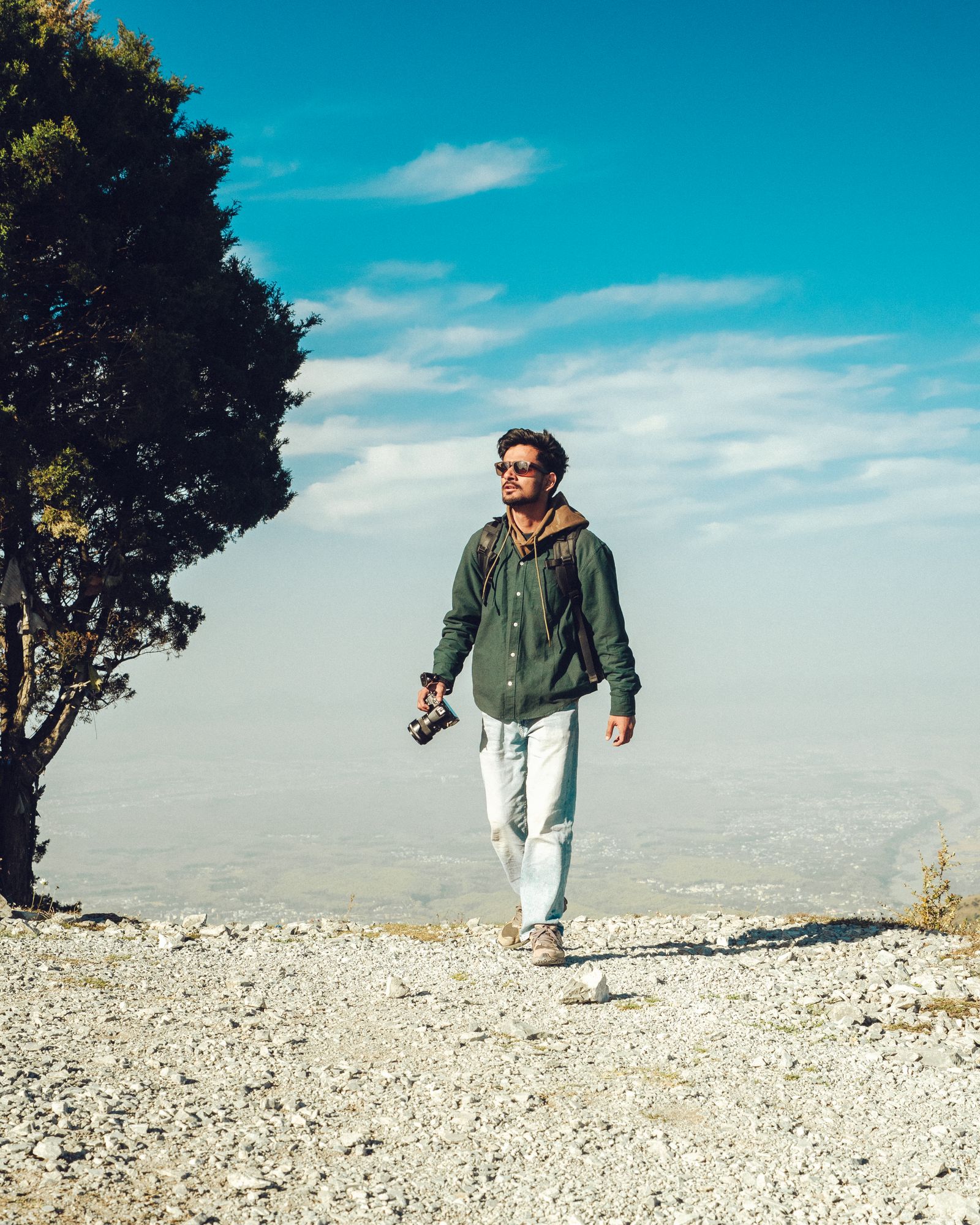 A traveler exploring an open mountain landscape