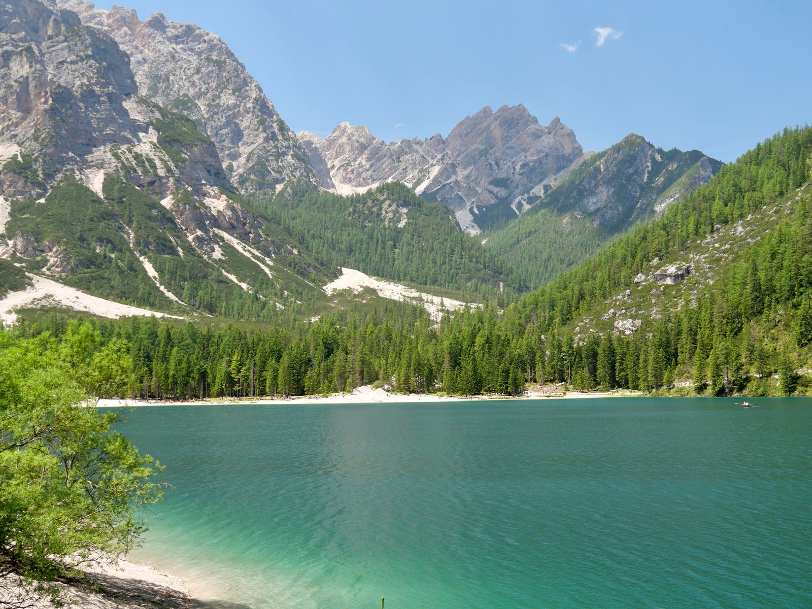 A turquoise lake beneath the dramatic peaks of the Dolomites